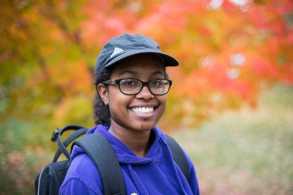 A student wearing a backpack outdoors